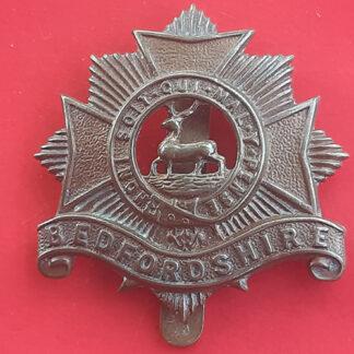 The Bedfordshire Regiment - Economy Issue Gilding Metal Cap Badge