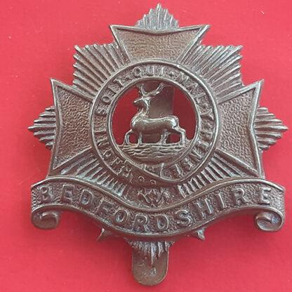 The Bedfordshire Regiment - Economy Issue Gilding Metal Cap Badge