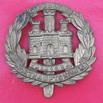 The Northamptonshire Regiment - WW1 Economy Issue Gilding Metal Cap Badge