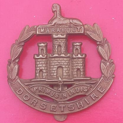 The Dorsetshire Regiment - WW1 Economy King's Crown Gilding Metal Cap Badge