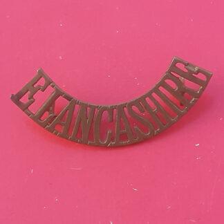 The East Lancashire Regiment - Gilding Metal Shoulder Title.