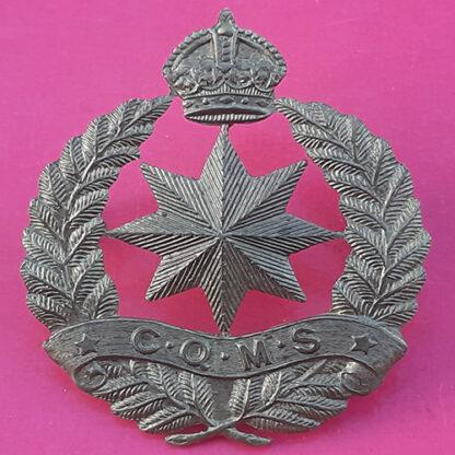 (New Zealand) - Camps C.Q.M.S - King's Crown Gilding Metal Cap Badge.