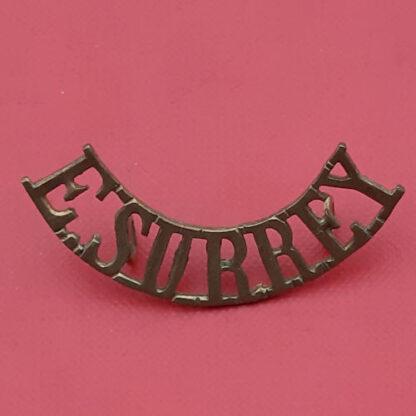 The East Surrey Regiment - Gilding Metal Shoulder Title.