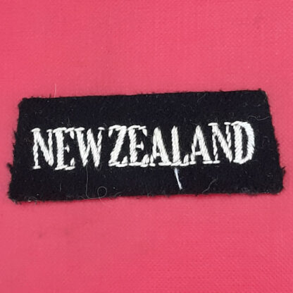(New Zealand) - White On Black Cloth Nationality Badge.