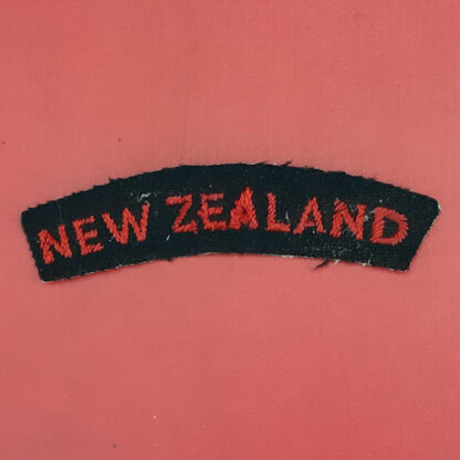 (New Zealand) - Red On Black Cloth Nationality Badge.