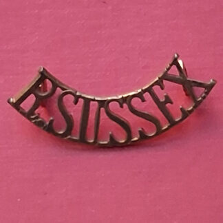 The Royal Sussex Regiment - Gilding Metal Shoulder Title.