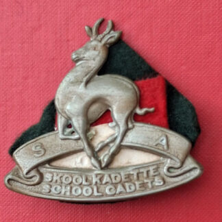 (South Africa) The South Africa School Cadets - White Metal Cap Badge With Cloth Backing.